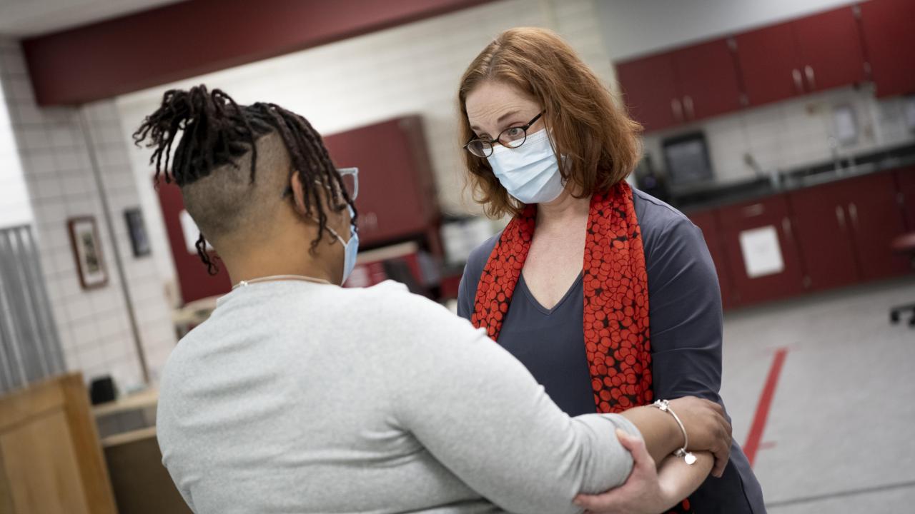 female doctor assisting a patient in a recovery exercise